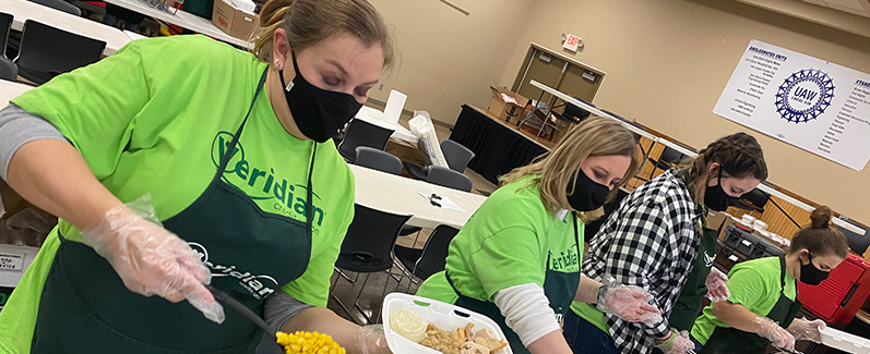 Veridian employees preparing free Thanksgiving dinner to go.