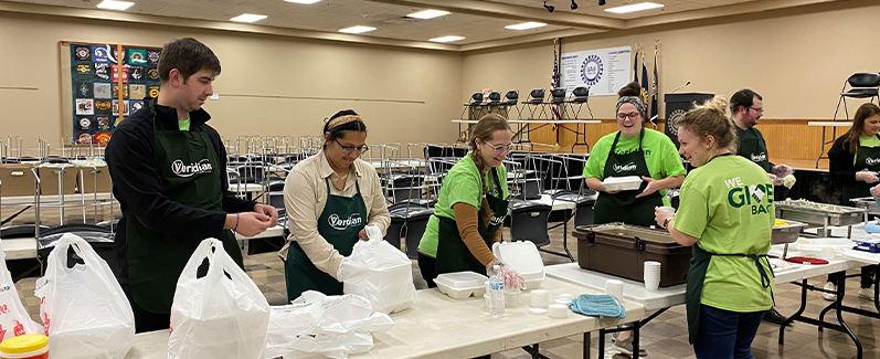 Veridian employee preparing free Thanksgiving dinner to go.