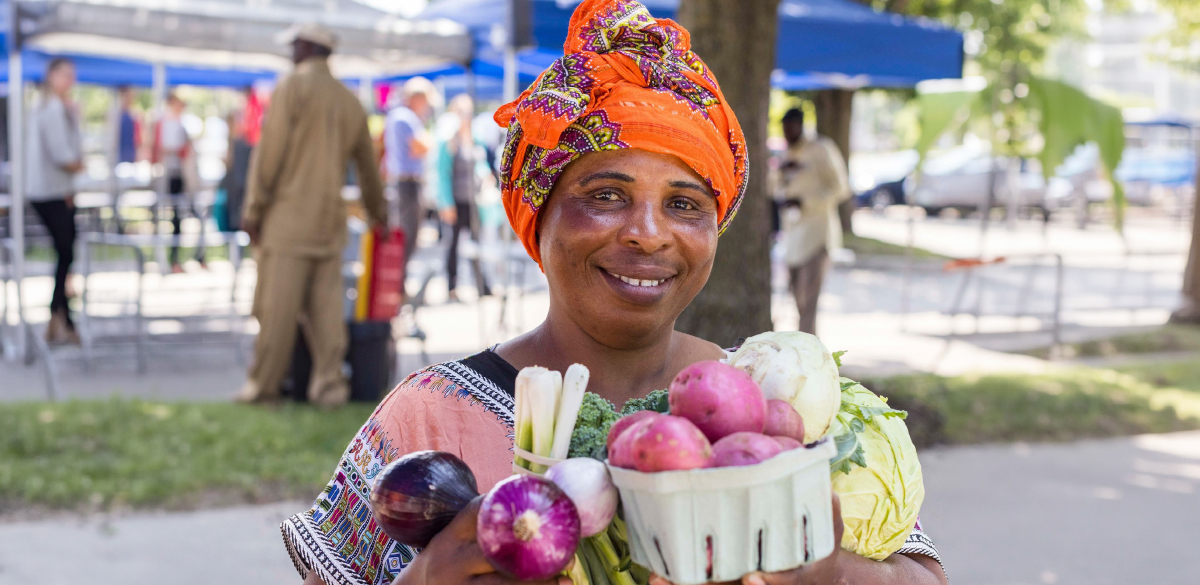 Market attendee or vendor with produce