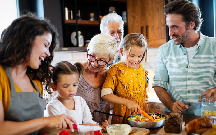 A multi-generation family preparing a holiday meal. 