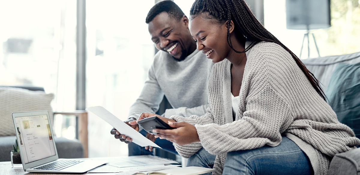 Couple reviewing computer and paperwork together