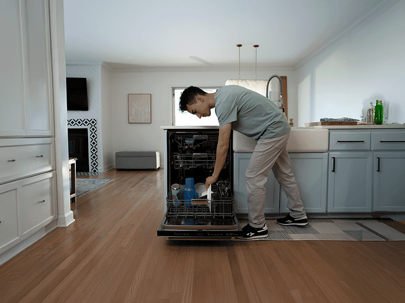 Boy playing airplane with his father on the floor